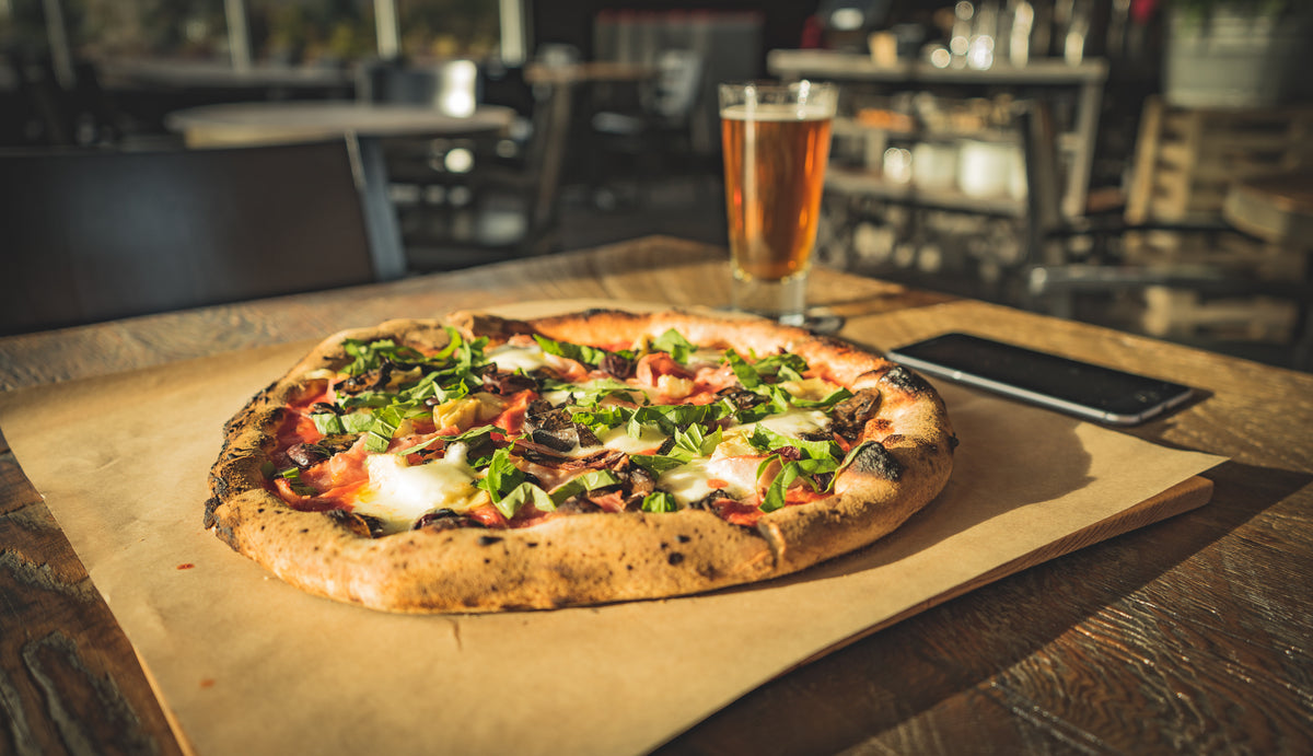 Dinner for one of wood-fired pizza paired with cold beer at Bezalel's Farm Kitchen