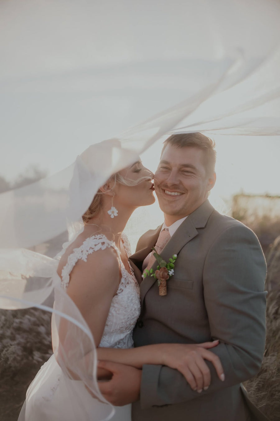 The bride and groom sharing a quiet moment together outdoors among the vines