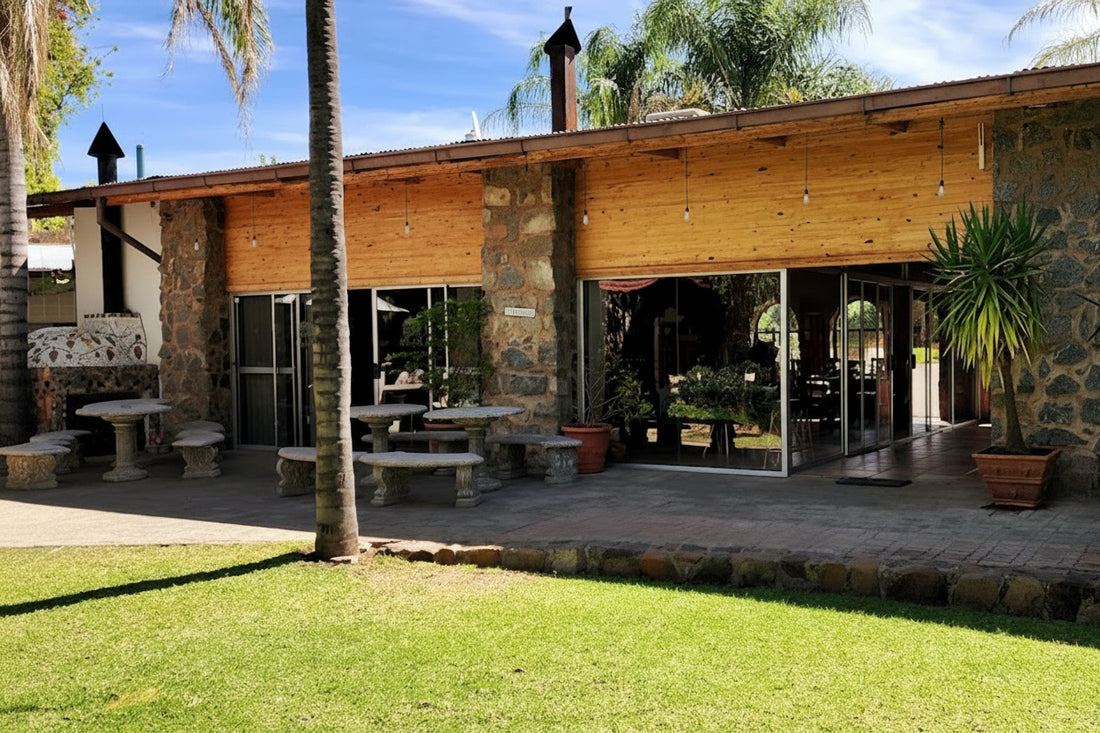 A long table laid at the farm kitchen, beneath the trees
