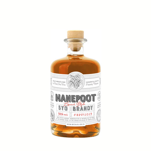 Elegant bottle of Bezalel Hanepoot Brandy with warm golden tones.
