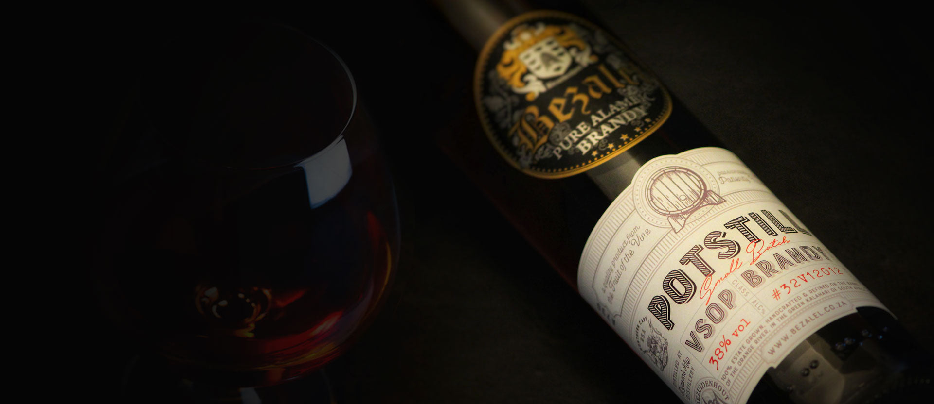 Bottle of Bezalel Estate Potstill Brandy with a cognac glass on a dark background