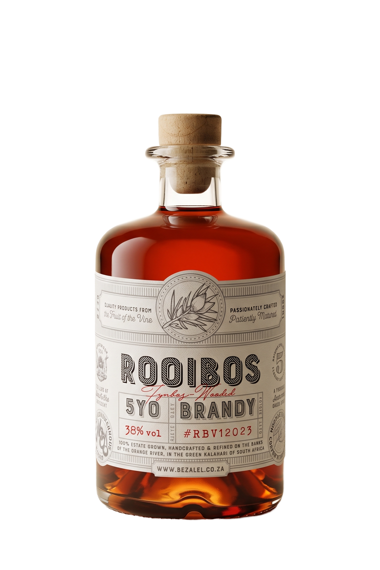 A bottle of RooibosFynbos-wooded 5YO Brandy by Bezalel, featuring a clear glass bottle filled with amber liquor, a cork stopper, and a cream-colored label with black and red text.