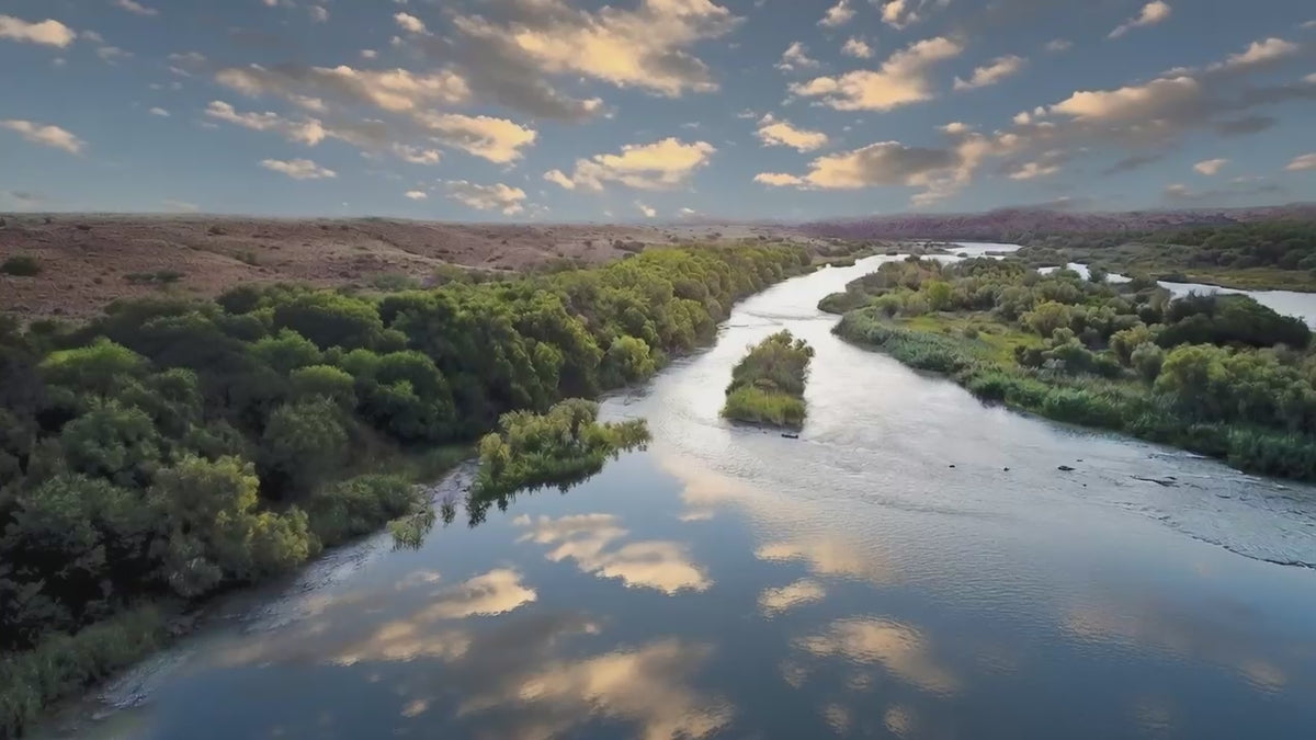 The Orange River winding green through red Kalahari earth