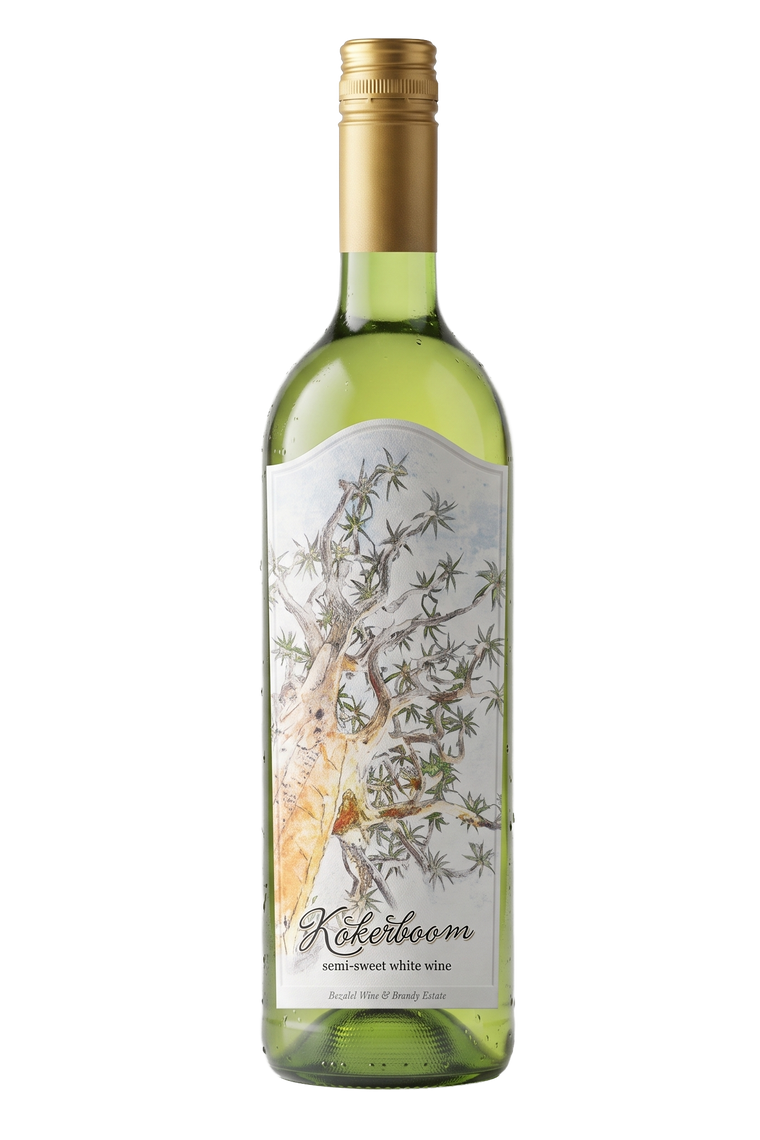 A bottle of Kokeboom semi-sweet white wine with a green glass bottle, a gold foil cap, and a white label featuring a watercolor illustration of a Quiver tree.